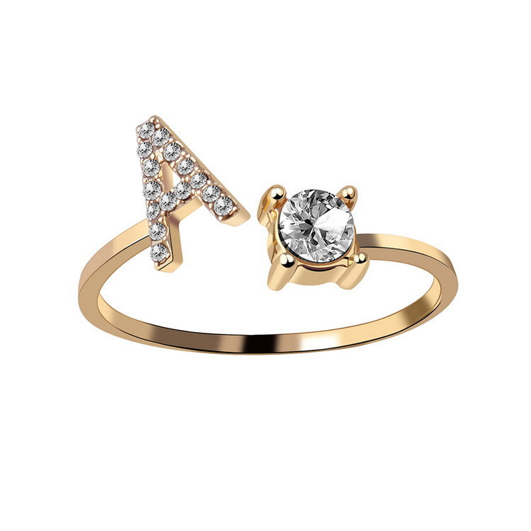 Gold initial letter ring worn on the finger