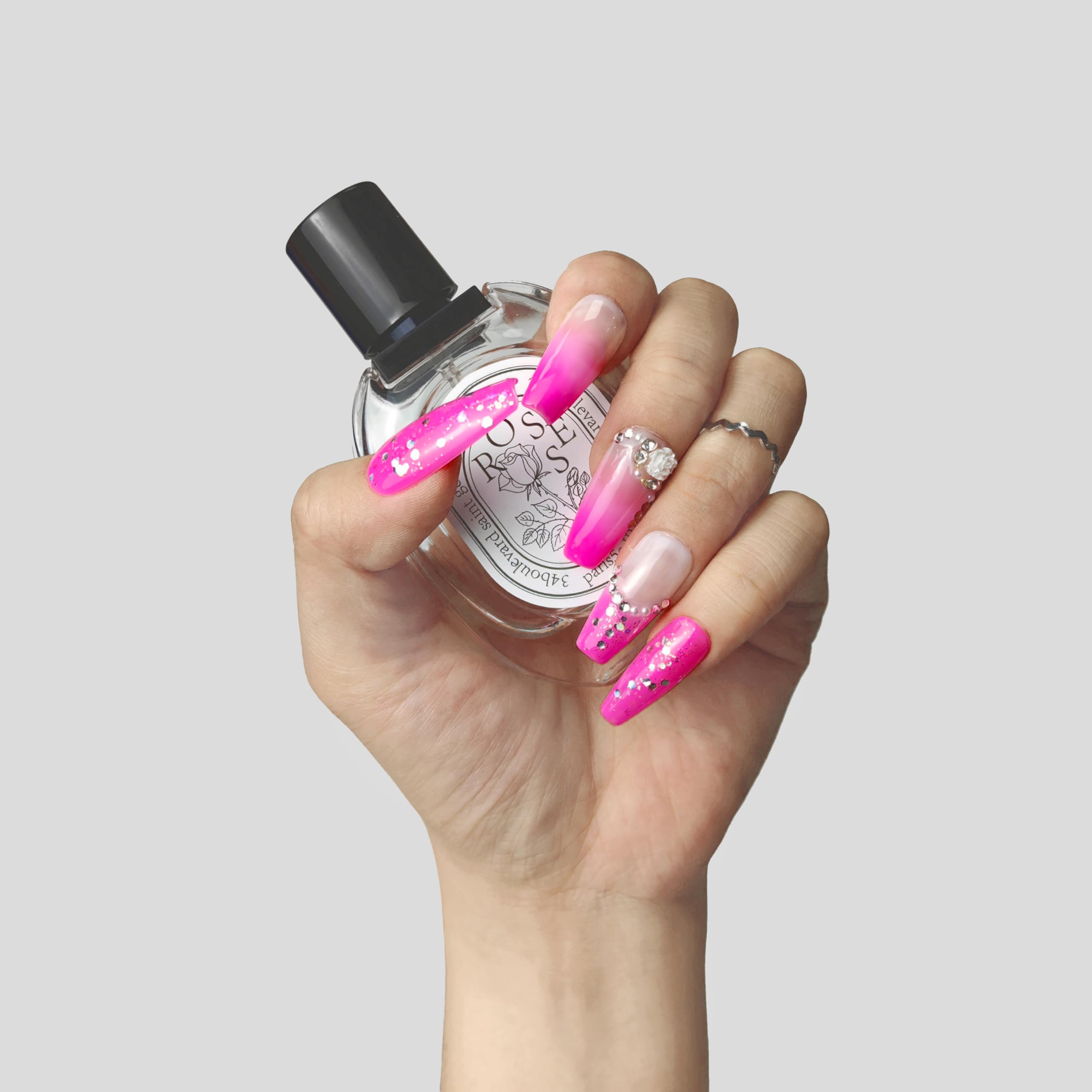 Handmade blush press-on nails styled on both hands