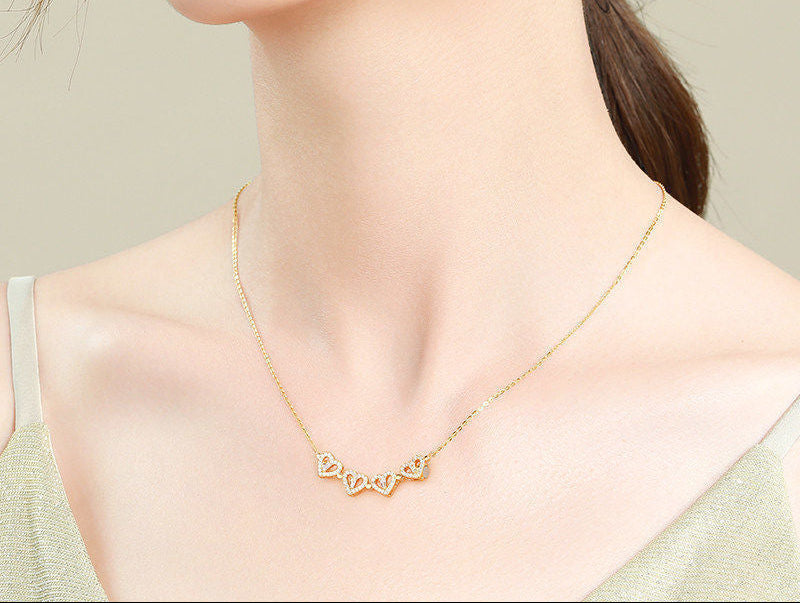 Four-leaf clover necklace opened into four heart pendants