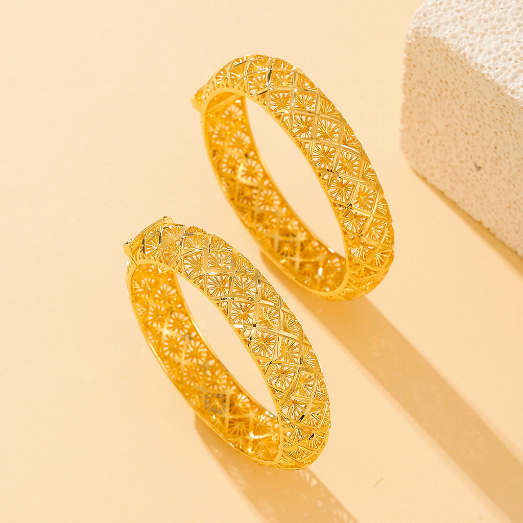 Gold-plated four-leaf clover bracelet shown at an angle on a plain background