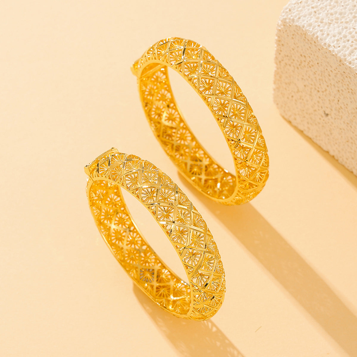 Gold-plated four-leaf clover bracelet shown at an angle on a plain background