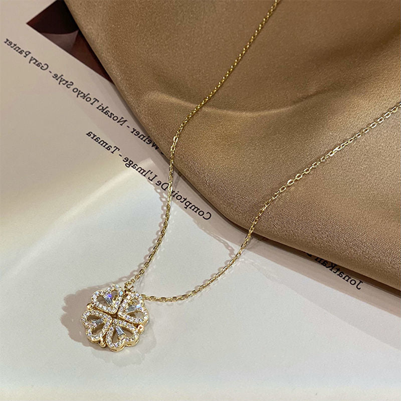 Four-leaf clover folding heart necklace worn at clavicle length