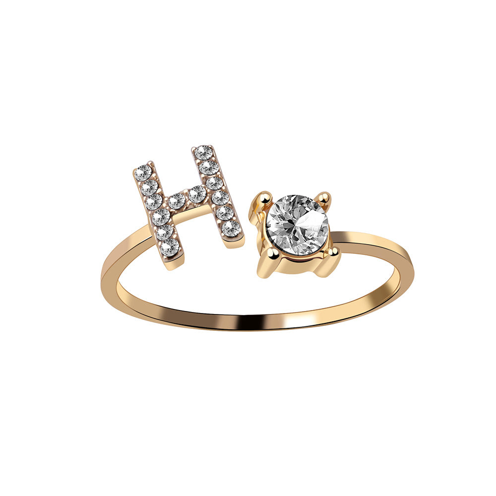 Initial letter ring with zirconia on a plain background