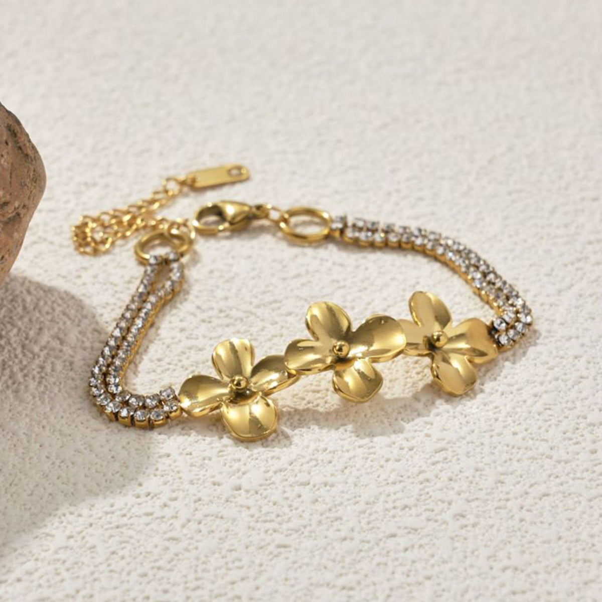 Close-up of the sculpted flower links on the gold-plated bracelet
